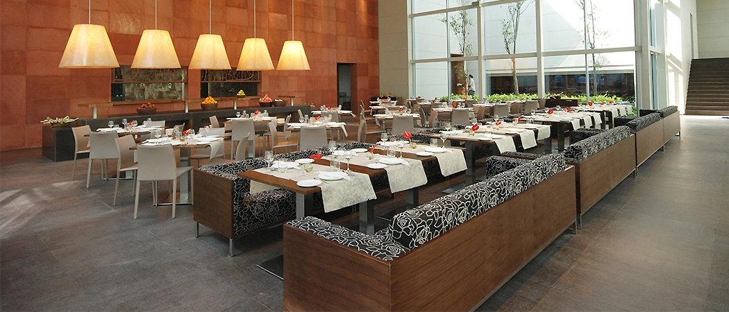 Fine dining restaurant interior in Nashik featuring decor, plush seating, and ambient lighting.